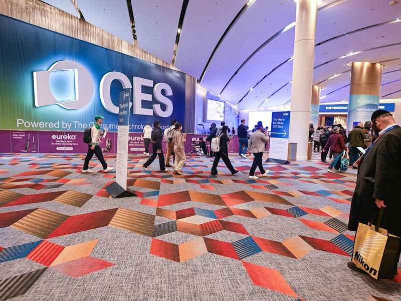 Attendees walking through the CES conference exhibition hall entrance.