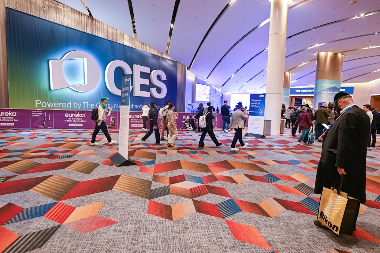Attendees walking through the CES conference exhibition hall entrance.