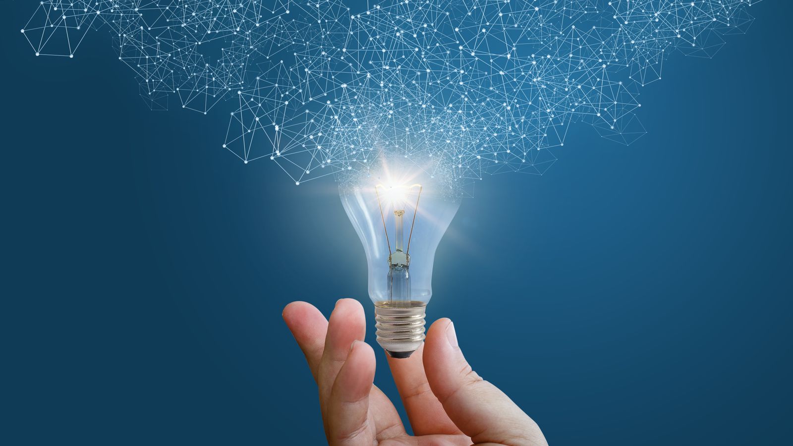 Hand holding a glowing light bulb with an abstract digital network pattern emanating from it, representing innovation and connected ideas.