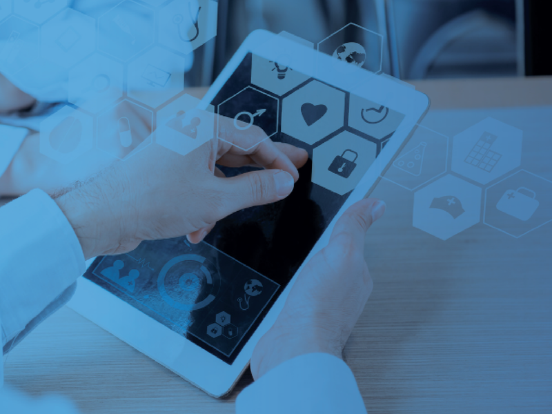 Person using a tablet with digital health and security icons overlaid, representing healthcare technology integration.