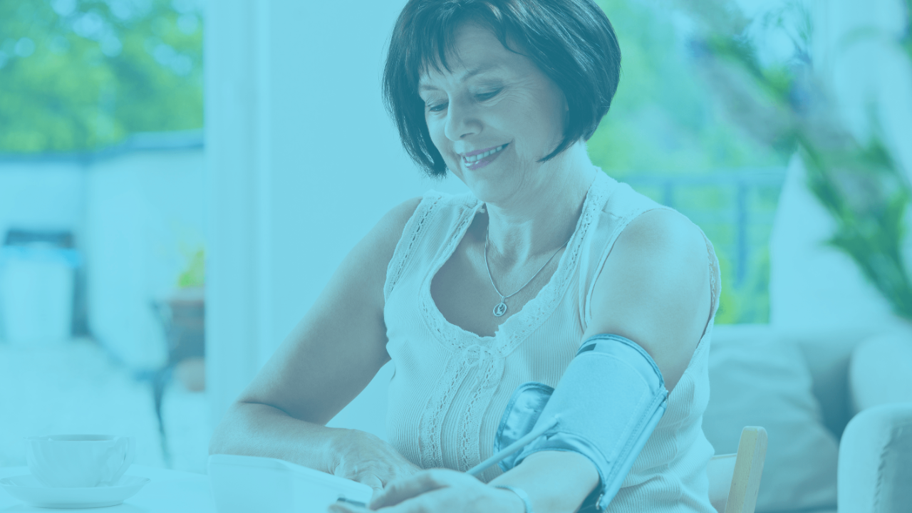 Woman using a blood pressure monitor at home, with a teal color overlay.