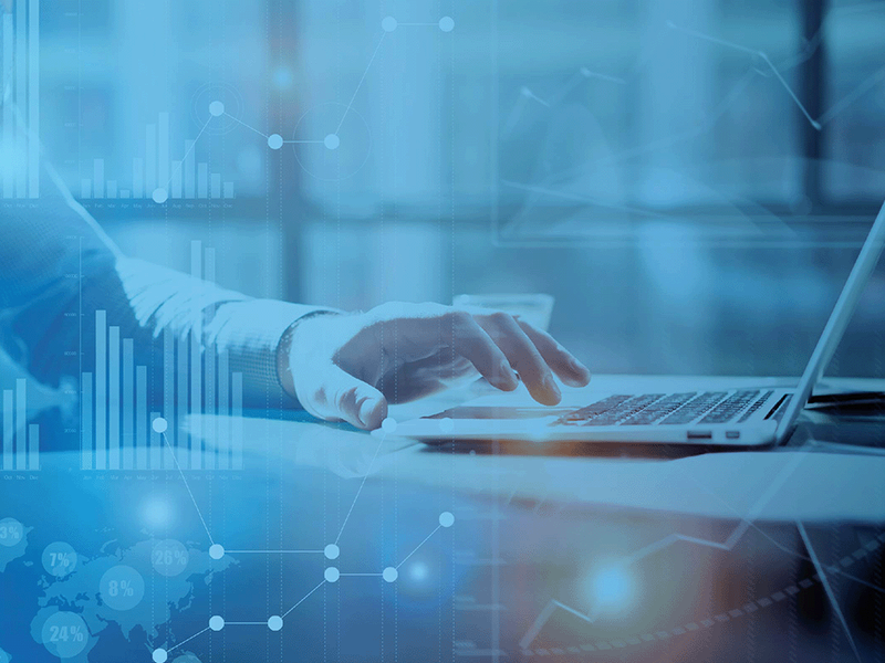 Business professional typing on a laptop with digital data charts overlaid, representing missed opportunities in healthcare analytics.