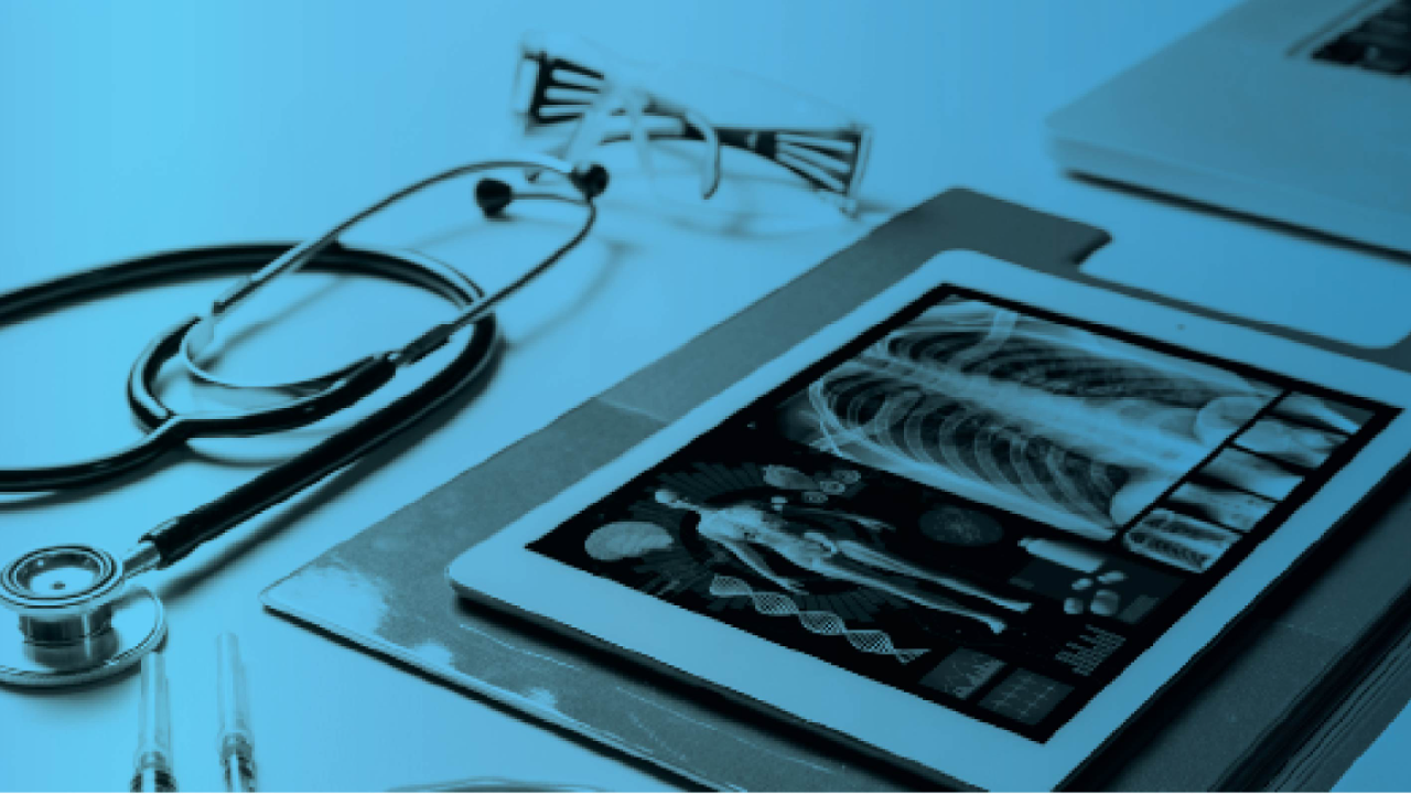 Stethoscope and tablet displaying a medical X-ray on a desk, with a blue tint overlay.