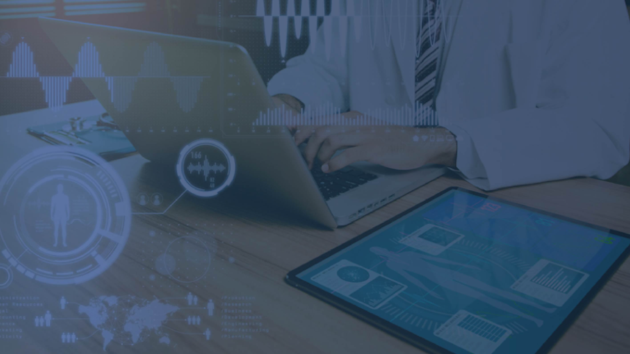 Healthcare professional typing on a laptop with digital health data overlays, with a blue tint.