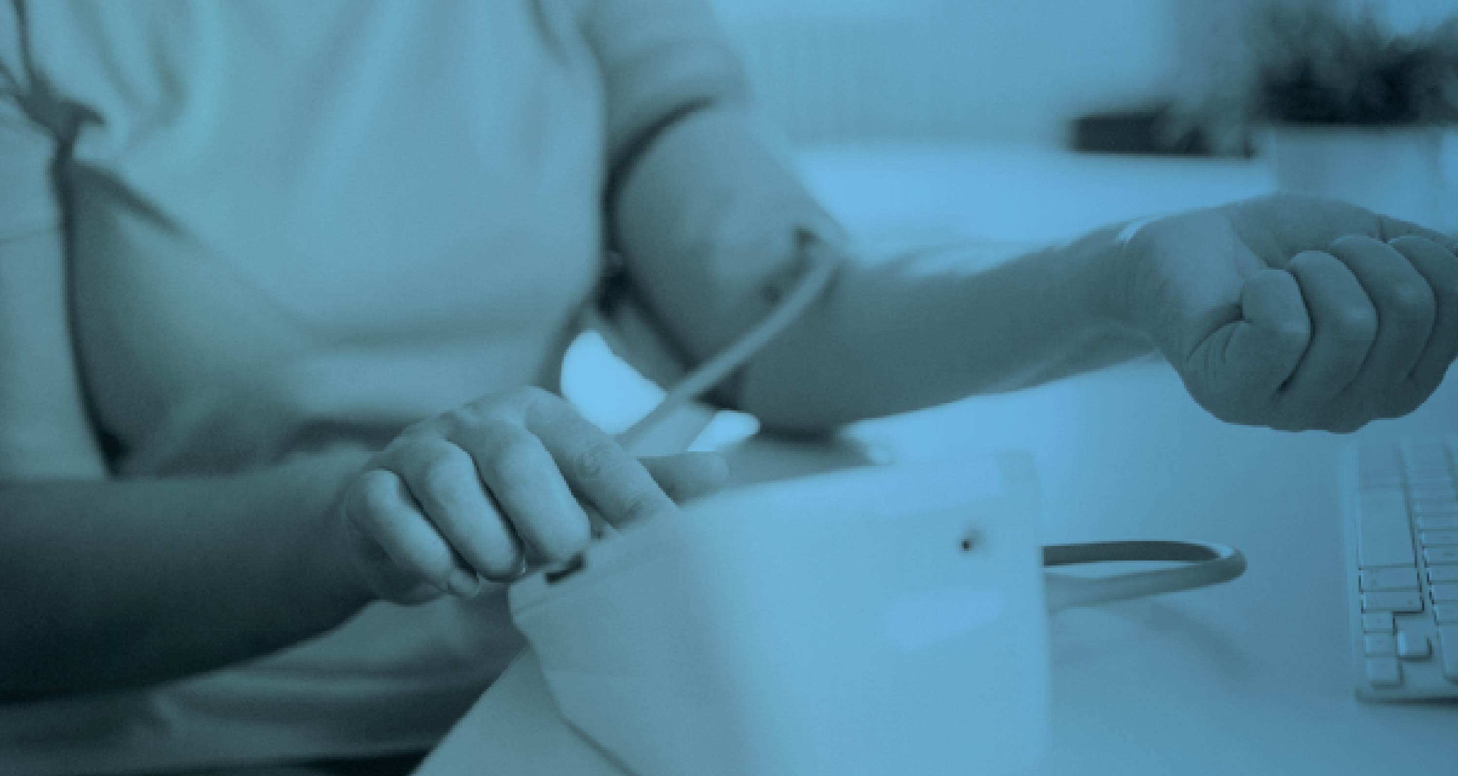 Close-up of a patient having their blood pressure taken with a cuff, shown with a blue color overlay